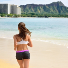 Woman jogging on Waikiki Beach in Honolulu