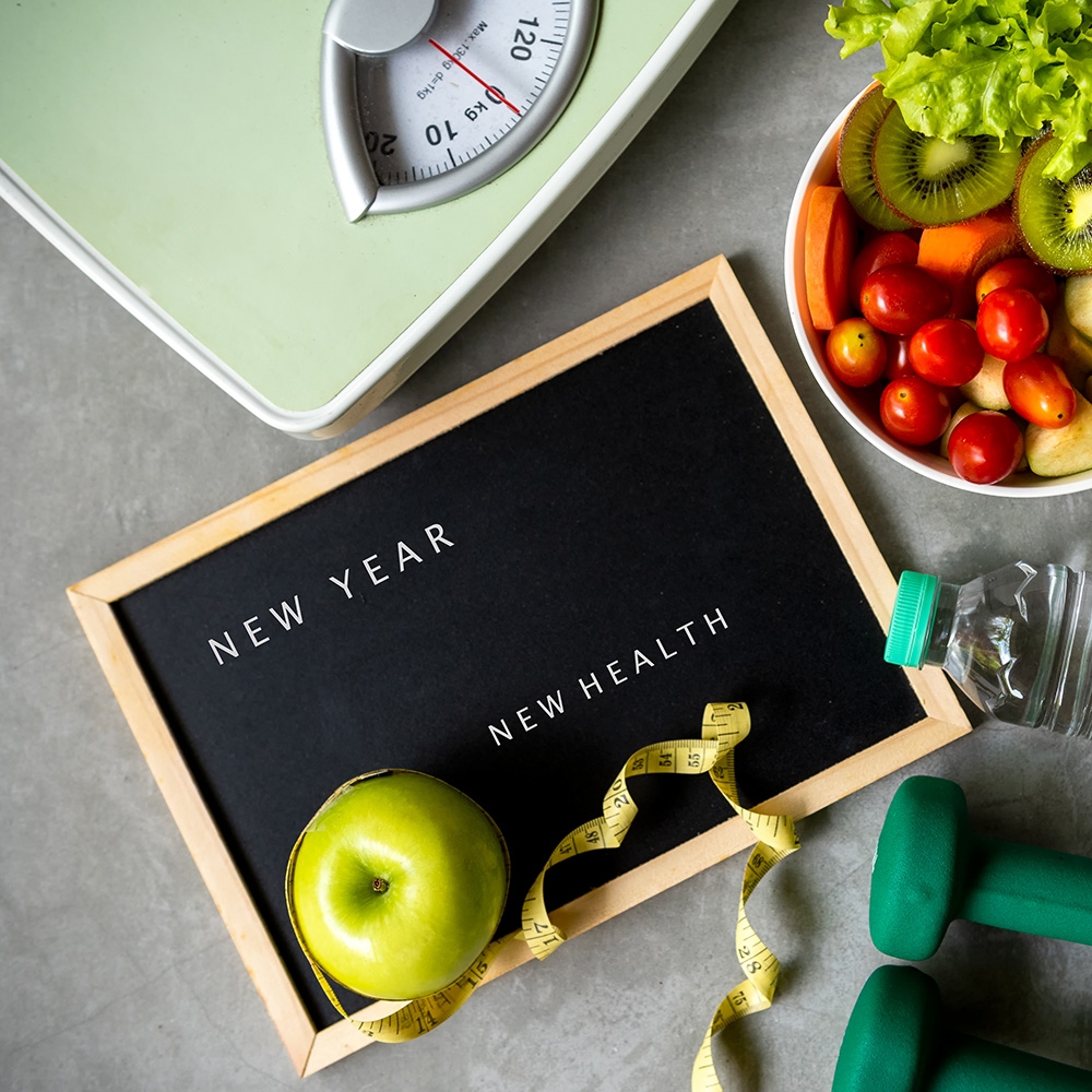 New Year for New Health sign with healthy food and workout items