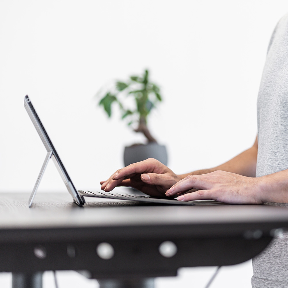 Asian man working at standing desk